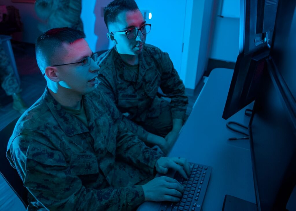 Two military personnel on a computer